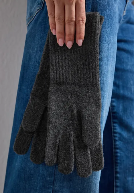 Feinstrick Handschuhe in Unifarbe anthracite melange Grau gestrickte Winterhandschuhe baumeln an der Jeanshose einer Person.