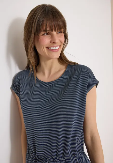 Knielanges Kleid aus Jersey universal blue Eine schlanke Frau steht vor weißer Wand und trägt ein dunkelblaues T-Shirt.