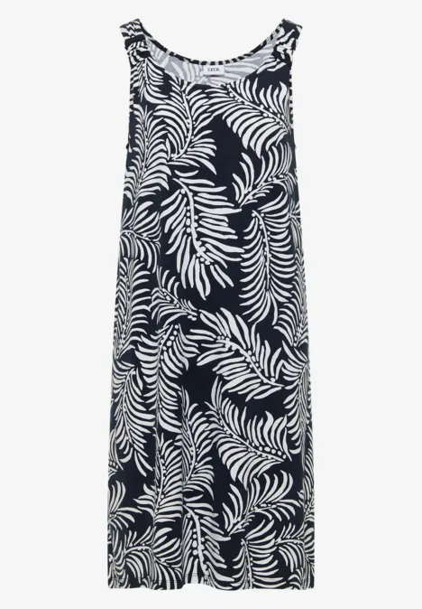 Ärmelloses Maxikleid mit weißem Blattmuster auf dunkelblauem oder schwarzem Grund.