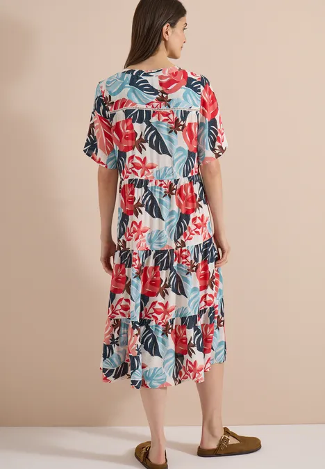 Robe mi-longue à col fendu et imprimé light alabaster white Vue arrière d’une femme portant une robe blanche mi-longue à imprimé floral coloré et manches amples sur fond neutre.