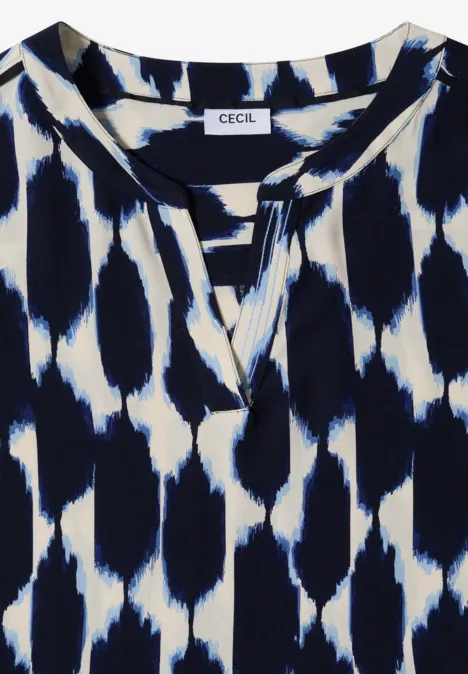 Knielanges Kleid mit Split Neck und Struktur urban dark blue Weiße Damenbluse mit dunkelblauem, abstraktem Tupfenmuster und kleinem Schlitz am Rundhalsausschnitt.