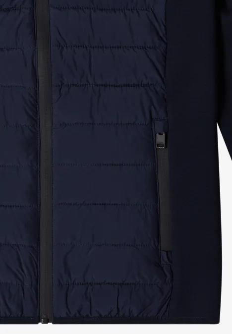 Dunkelblaue gesteppte Jacke mit durchgehendem Reißverschluss und zwei seitlichen Eingrifftaschen.