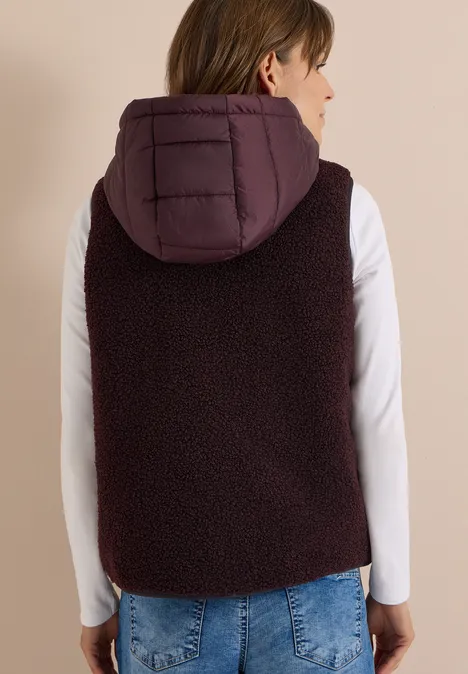 Teddy-Weste mit abnehmbarer Kapuze berry red Ärmellose, dunkelviolette Fleeceweste mit wattierter Kapuze, Rückansicht eines Models.