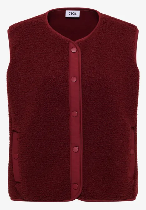 Teddy-Weste mit Softshelldetails russet red Ärmellose, dunkelrote Teddy-Fleece-Weste mit Knöpfen und seitlichen Taschen.