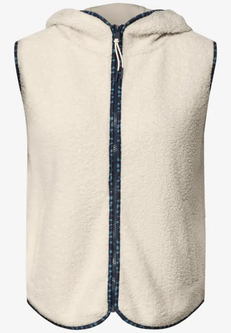 Ärmellose Kapuzen-Weste aus cremefarbenem Teddyfleece, mit Reißverschluss und blau gemustertem Zierband