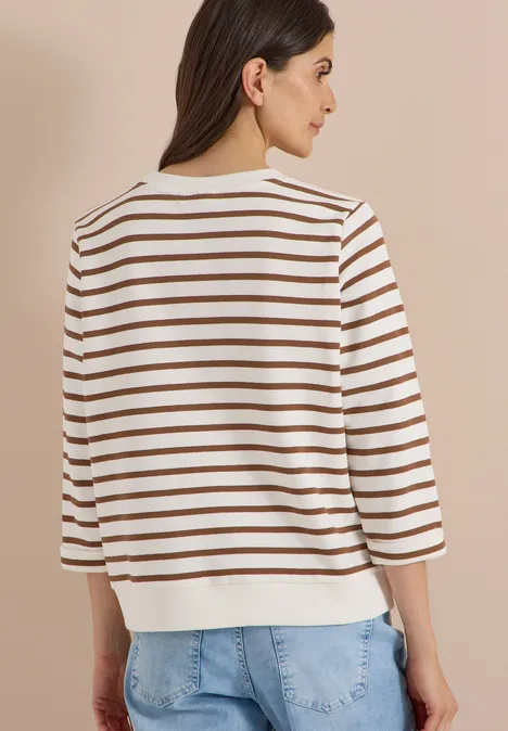 3/4-Arm Sweatshirt mit Rundhals und Streifen creamy mocha Eine Frau mit dunkelbraunen Haaren von hinten, trägt ein weißes Shirt mit braunen Streifen und blaue Jeans.
