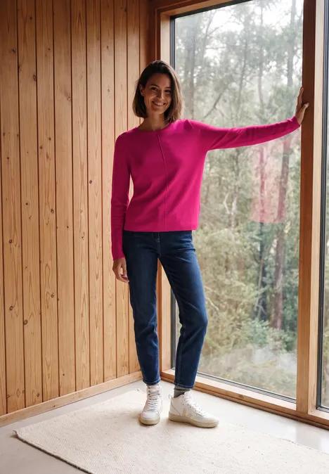 Langarm Pullover mit Rundhals und Struktur pink flash Eine Frau in pinkem Pullover und Jeans steht an großer Fensterfront.