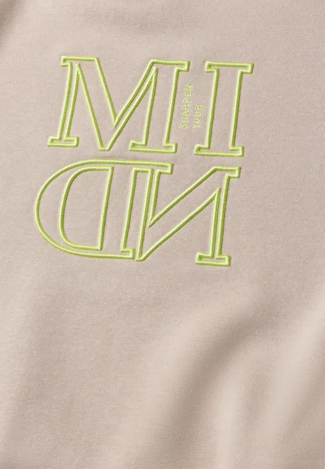 Sweatshirt mit Kapuze und Artwork snow cloud beige Beige Stoff mit neongrüner Aufschrift 'MIND', wobei 'ND' spiegelverkehrt dargestellt ist.
