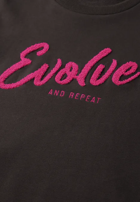 Schwarzes Shirt mit pinkem Schriftzug "Evolve and Repeat"