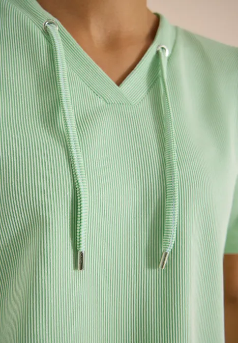 Gestreept shirt juicy lime Close-up van een lichtgroene, geribbelde V-hals top met capuchonkoordjes.