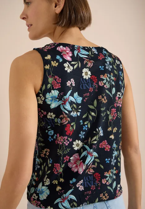 Haut sans manches à motif floral coloré sur fond sombre, vue arrière