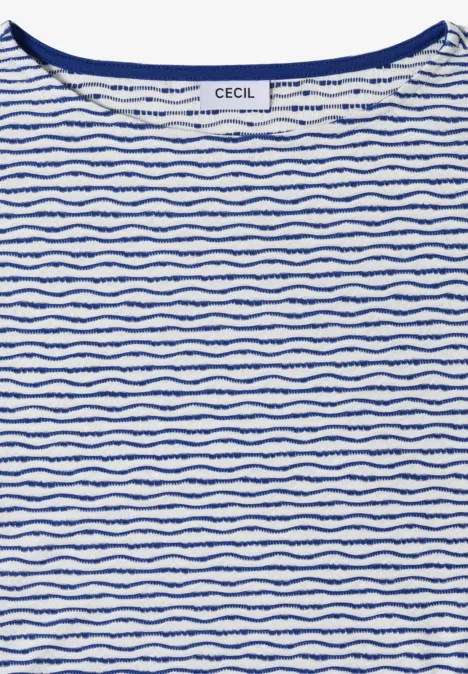 T-shirt blanc à col rond avec fines rayures bleues ondulées et irrégulières.