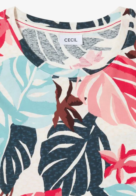 Hellgemusterter Stoff mit bunten tropischen Blättern und Blumen, dazu ein CECIL-Label