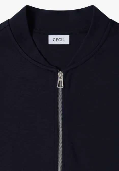 Veste bleu marine à fermeture éclair avec étiquette CECIL sur le col.