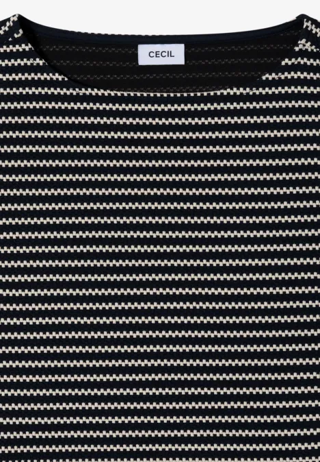 Opgevouwen shirt met zwart-wit zigzagpatroon en ronde hals.