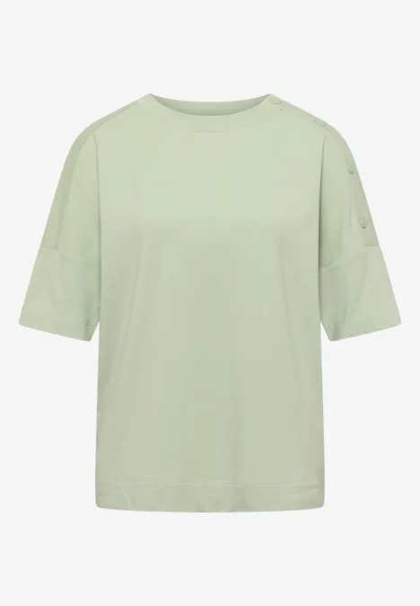 T-shirt ample de couleur vert pastel clair, manches courtes, col rond, style sobre et moderne.