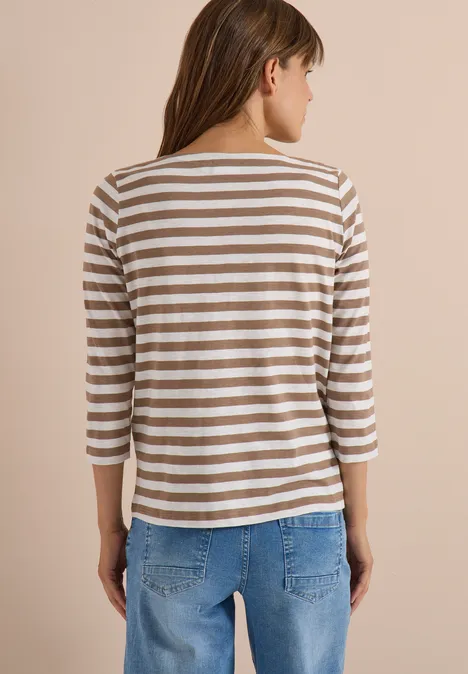 Basic Shirt met boothals en strepen natural taupe Frau von hinten in gestreiftem Dreiviertelarm-Shirt und blauen Jeans vor neutralem Hintergrund.