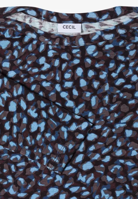 Haut marron à motif de taches bleues et étiquette de marque « CECIL ».