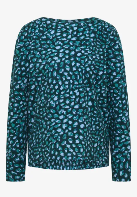 Haut à manches longues motif abstrait turquoise et noir.