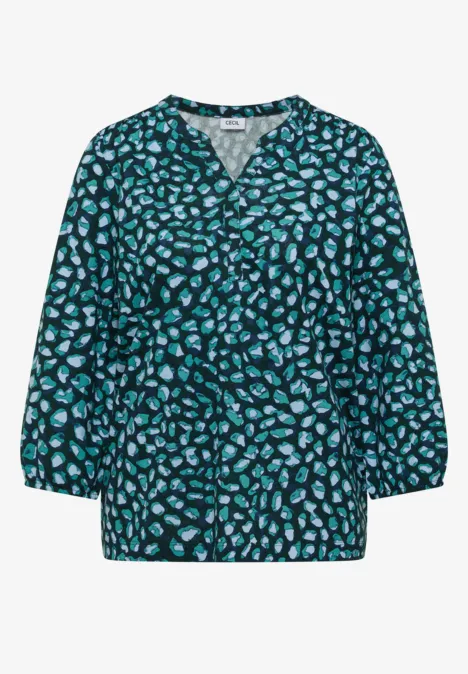 Chemisier vert foncé à coupe ample, col V et motif floral turquoise, manches 3/4.