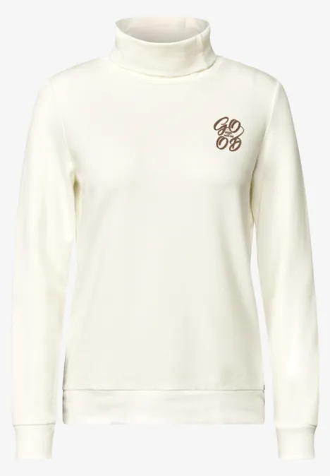 Witte coltrui met lange mouwen en klein monogram op de borst.