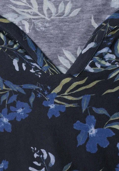 Dunkelblauer Stoff mit floralem Muster in Blau- und Grüntönen.