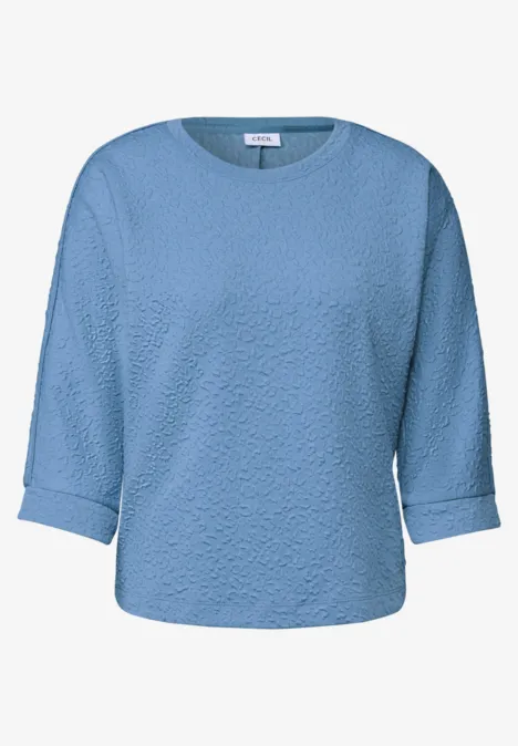 Pull bleu clair à manches 3/4 et col rond.