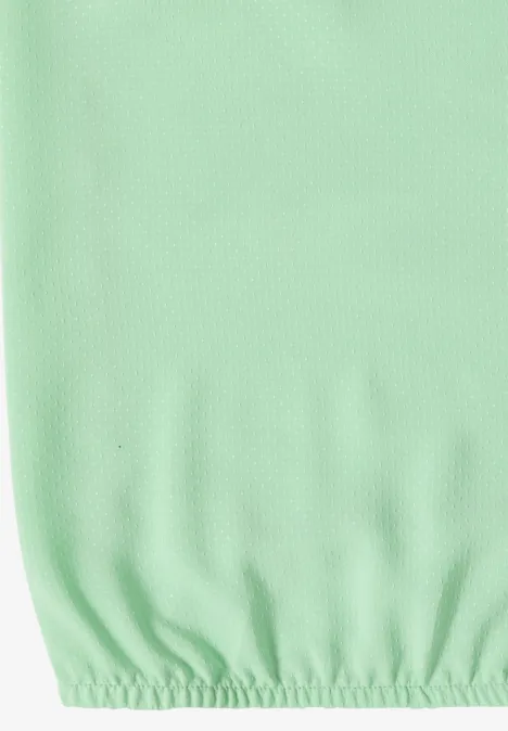 Pastelgroen hoeslaken met elastische rand en fijne structuur.