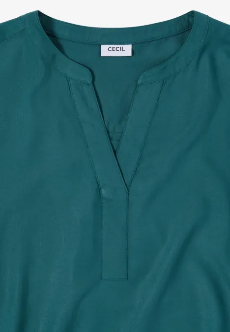 Damesblouse in petrol met V-hals, lange mouwen en 'CECIL'-label.