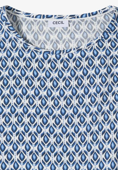 Weiß-blau gemustertes ärmelloses Damenoberteil mit ovalen Mustern und rundem Halsausschnitt.