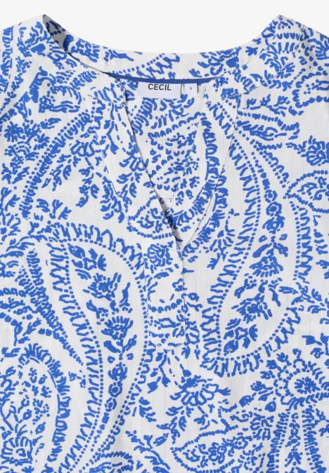 Ärmelloses Oberteil mit blauem Paisley-Muster auf weißem Grund und Bindeband im Ausschnitt.