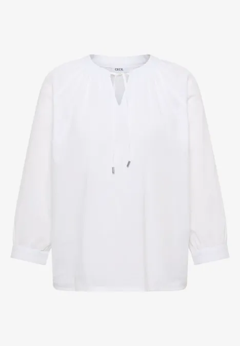 Witte blouse met lange mouwen, losse pasvorm en bindlint bij de halsopening.