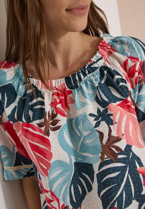 Sommerbluse mit buntem tropischem Blattmuster in Blau, Rosa und Weiß.