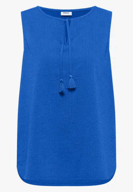 Ärmellose, blaue Damenbluse mit Rundhalsausschnitt und dekorativen Quasten am Vorderteil.
