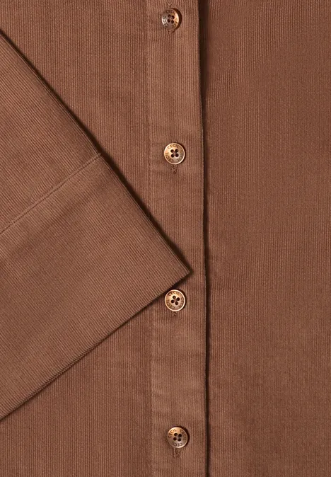 Overhemd met korte mouwen in effen kleur creamy mocha Close-up van een bruin overhemd met knoopsluiting en manchet.