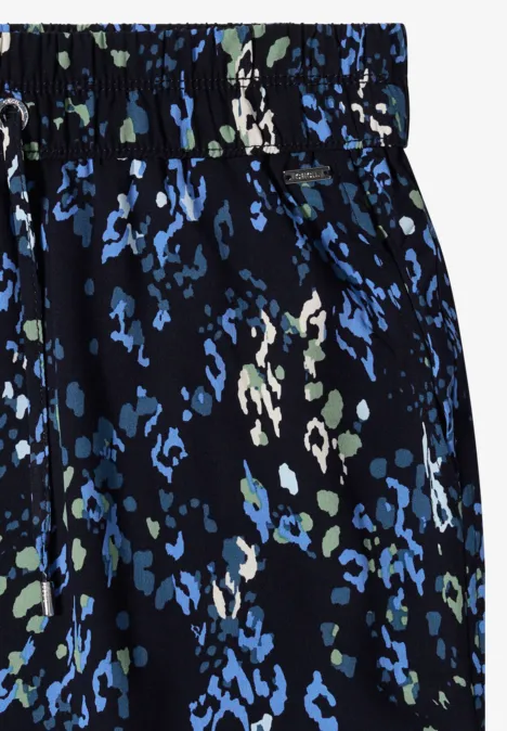 Knielanger Rock mit Elastikbund und Print urban dark blue Schwarzer Rock mit elastischem Bund und blau-grünem Blumenmuster.