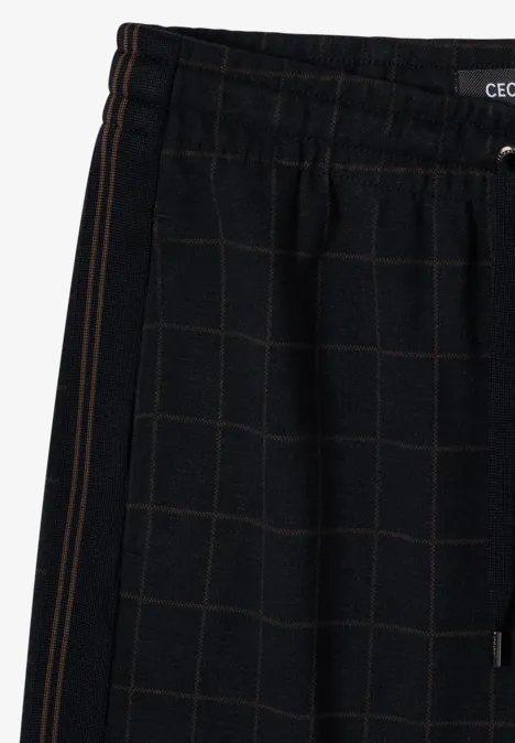Knielanger Rock mit Tapedetails urban dark blue Schwarze Jogginghose mit kariertem Muster, elastischem Bund und seitlicher Tasche.