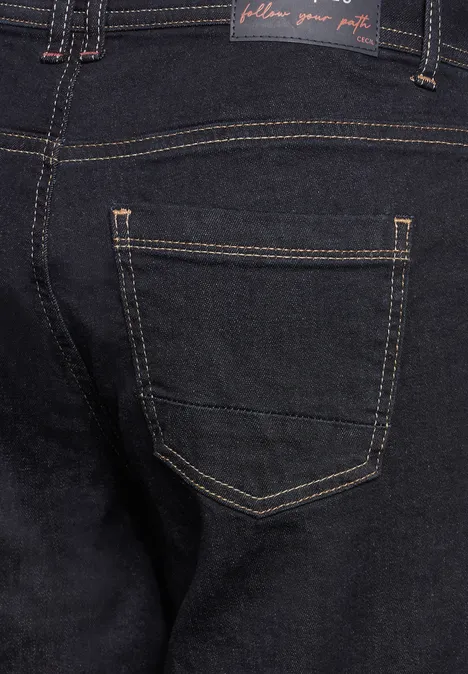 Gros plan sur la poche arrière d’un jean bleu foncé.