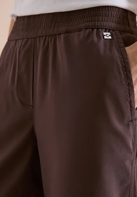 Donkerbruine joggingbroek met elastische tailleband en zijzak.