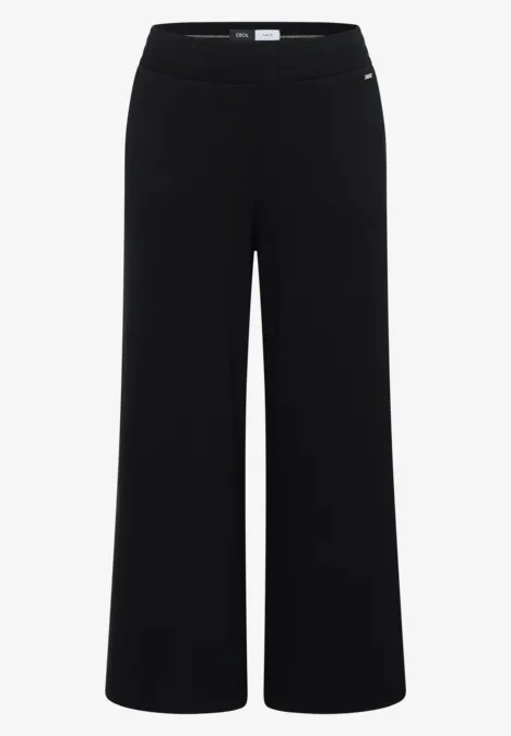 Pantalon noir ample taille haute en tissu fluide.