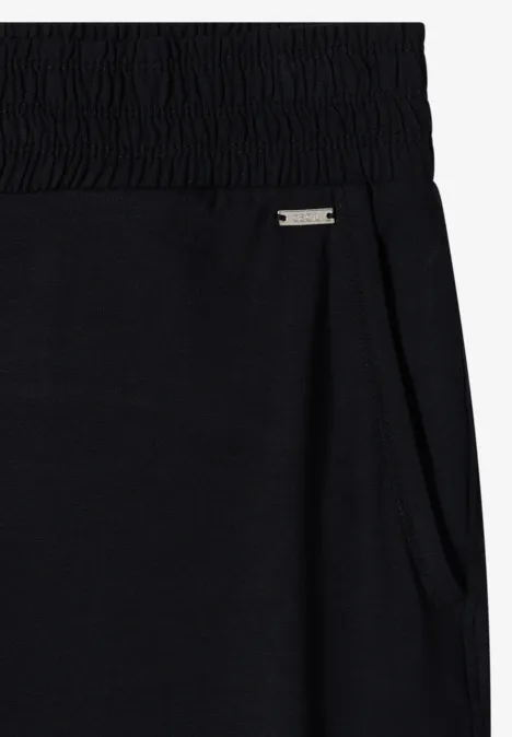 Schwarze Sweatpants mit elastischem Bund, Seitentasche und kleinem Metall-Label.