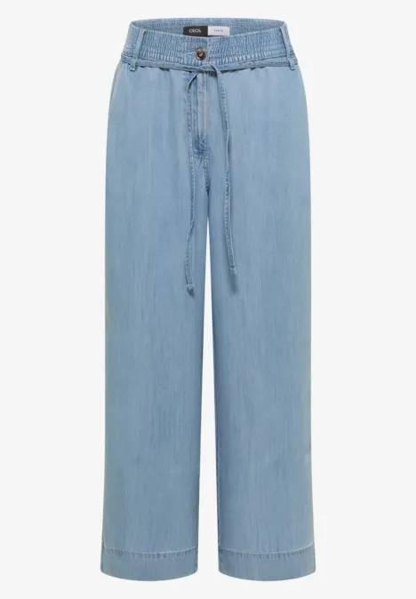 Lichtblauwe, wijde jeansbroek met hoge taille, koordsluiting en rechte pijpen.