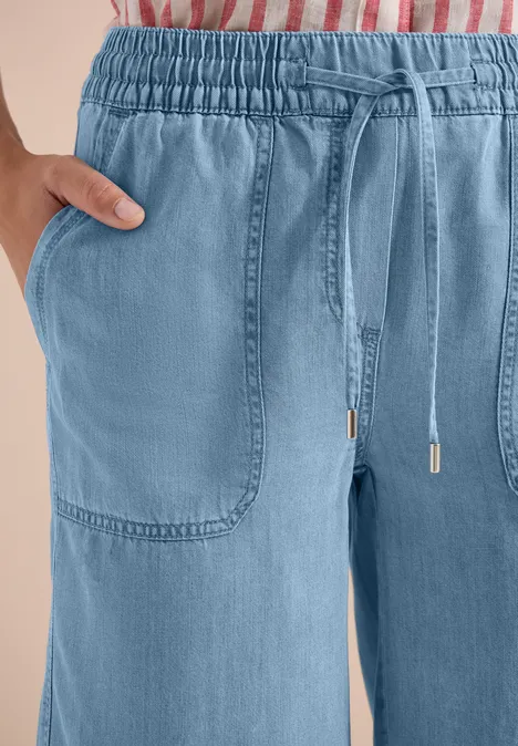 Hellblaue, bequeme Hose mit Gummibund, Tunnelzug und aufgesetzten Taschen.