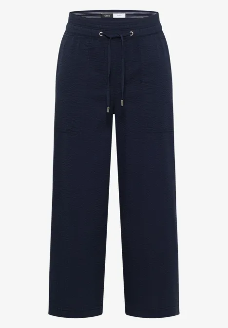 Donkerblauwe, losse broek met hoge taille, trekkoord, comfortabele pasvorm en grote voorzakken.