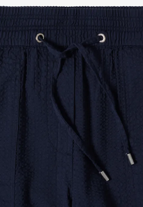Donkerblauwe sweatpants met elastische taille, aantrekkoord en gestructureerde tricotstof.