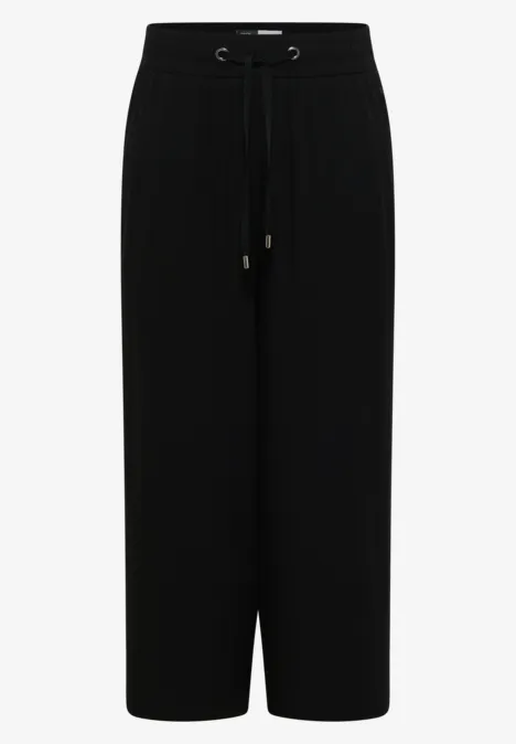 Zwarte, losse broek met aantrekkoord, rechte pasvorm en enkellange wijdte.
