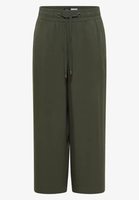 Pantalon ample kaki coupe large et raccourcie, taille élastique avec cordon.