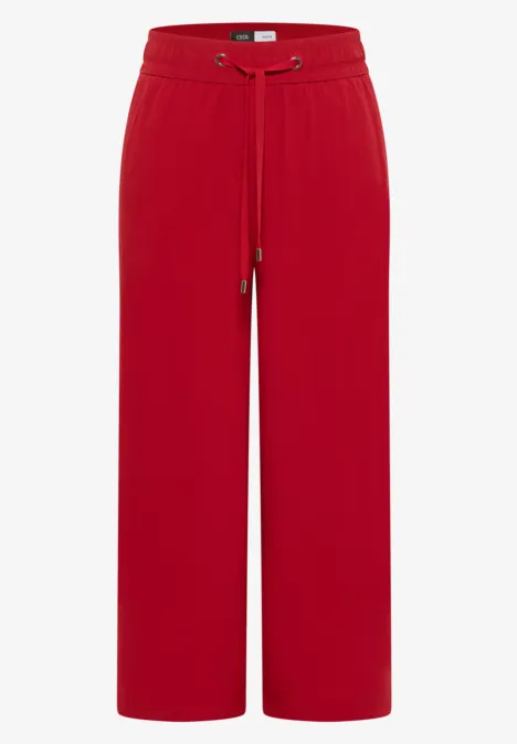 Rode wijdvallende broek met elastische tailleband en trekkoord, losse pasvorm.