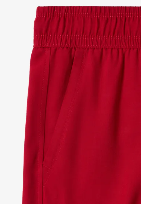 Rode broek met elastische tailleband en zijzak.