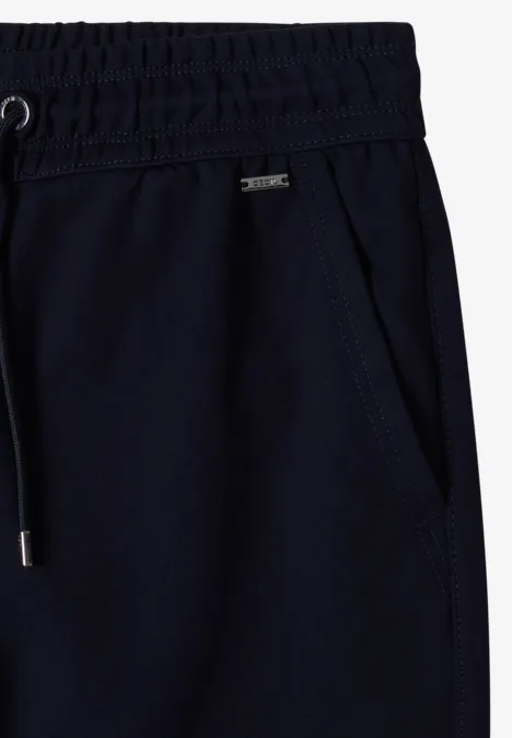 Pantalon de jogging bleu marine à taille élastique, poche latérale et cordon de serrage à embouts métalliques.
